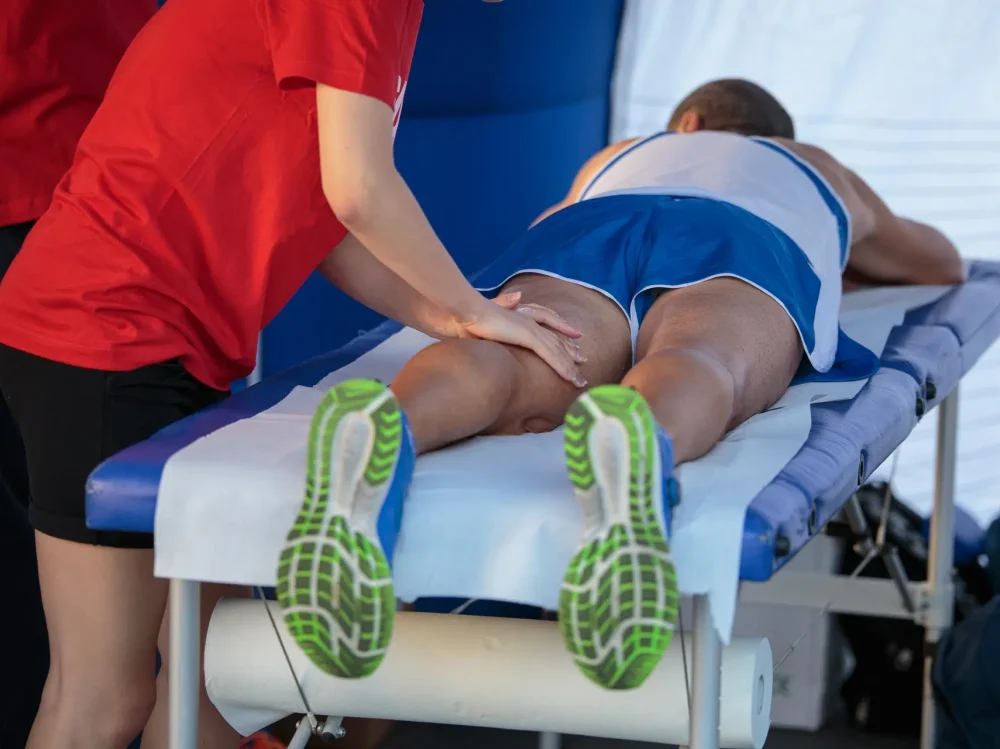 Physiotherapist assisting patient with sports recovery physiotherapy healing in Edmonton